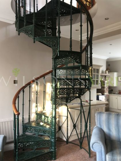 Original Victorian cast iron spiral staircase with intricate fleur de lys detailing